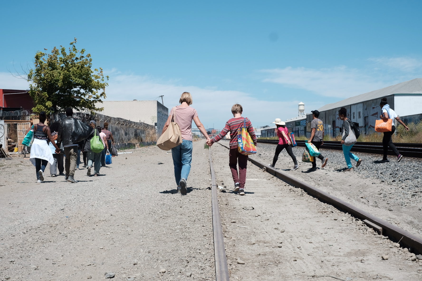 EOC outreach team walking the railroad corridor with supplies for unhoused neighbors