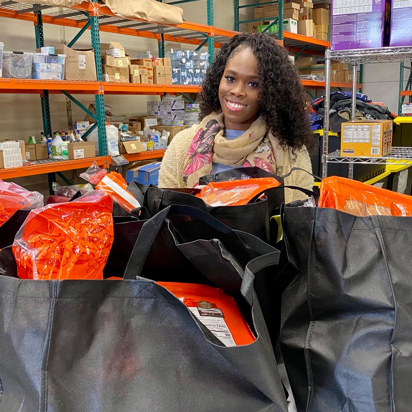 Porsha with bags of groceries prepared for distribution